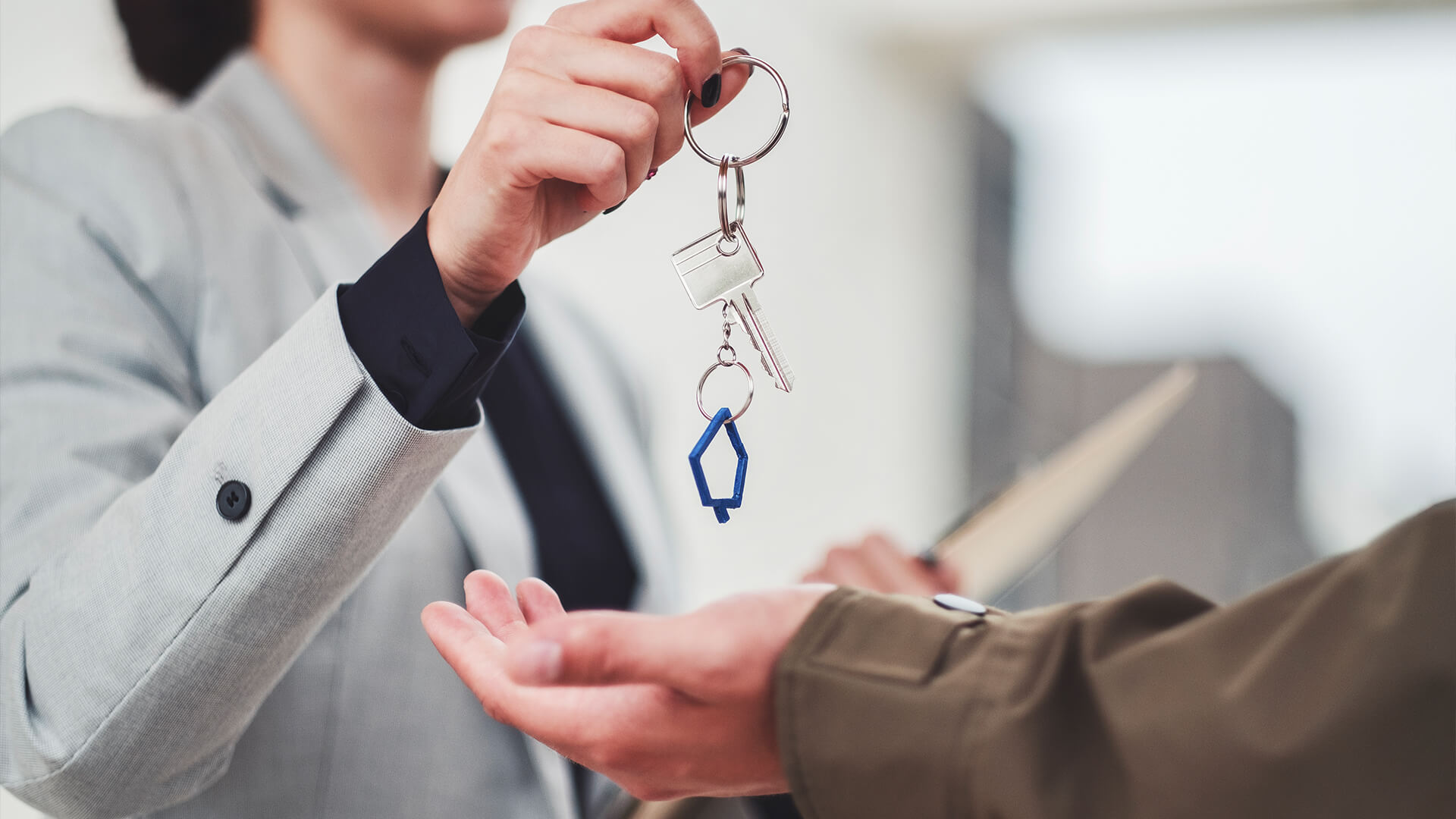 Realtor handing keys to new homeowner