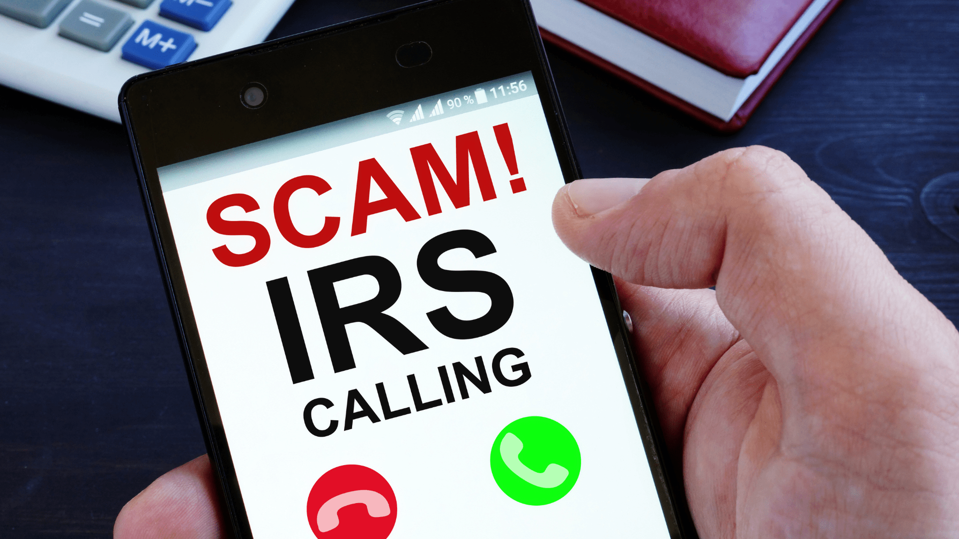 cell phone with SCAM IRS calling on front screen